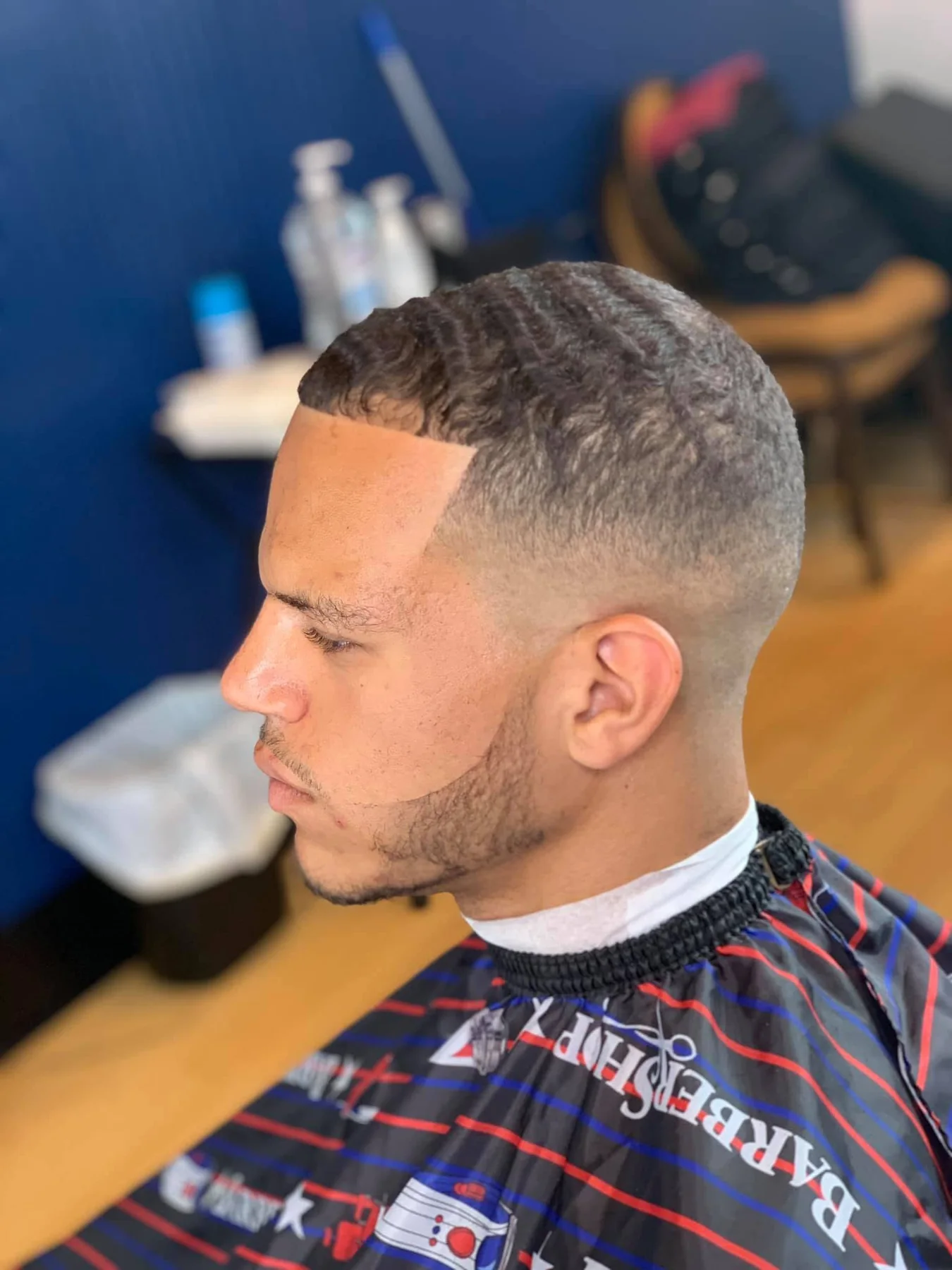 Three-quarter view showing textured waves, a smooth fade, and a clean frontal lineup